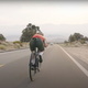 A screenshot from a video of a bike riding down a hill. The speed in the corner reads 62mph.